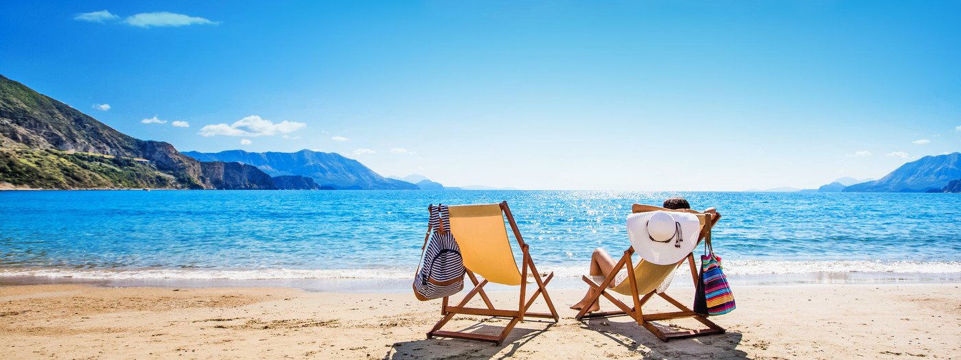 Woman enjoying sunbathing at beach. Summer vacation