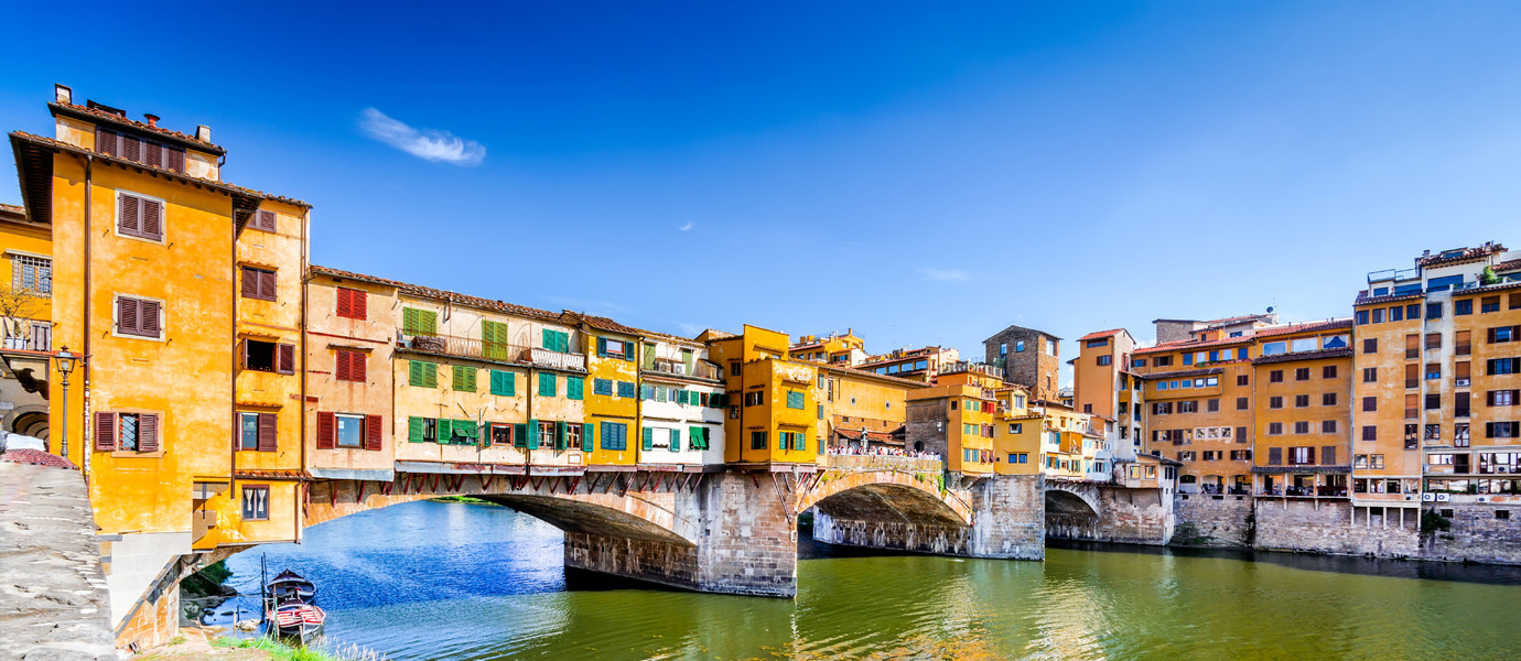Florence, Tuscany - Ponte Vecchio, medieval bridge sunlighted over Arno River, Italy.